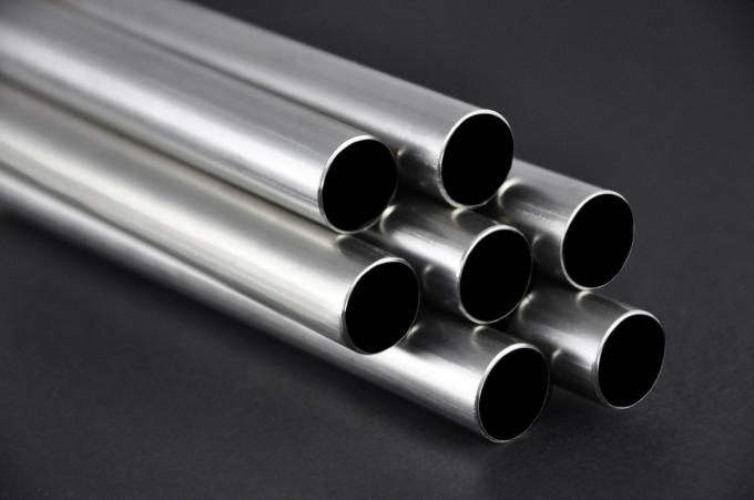 A collection of stainless steel 310 pipes arranged in a row, showcasing their smooth, shiny surfaces and cylindrical shapes.